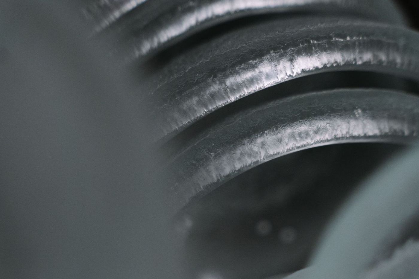 Tightly wound steel torsion spring coil of the type mounted above a residential garage door