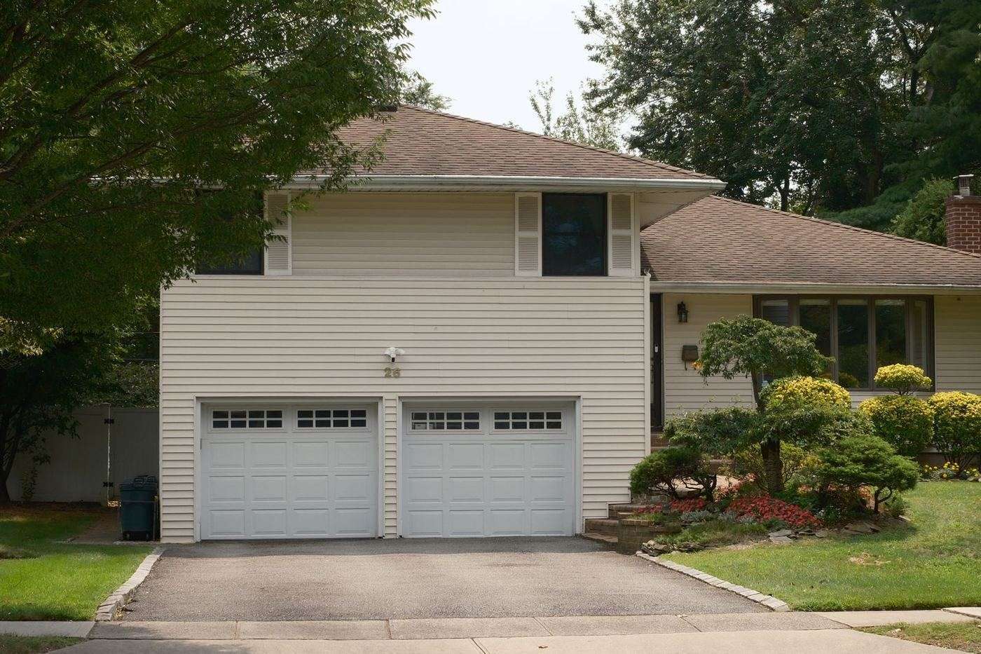 Split-level Robinson home with two single garage doors and a mature front lawn
